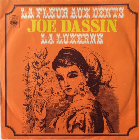 Joe Dassin - La Fleur Aux Dents Vinyl Singles Vinyl Very Good (VG) <br> Hoes Good Plus (G+)